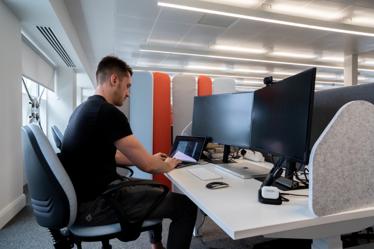A man working at a private desk in the Plaza