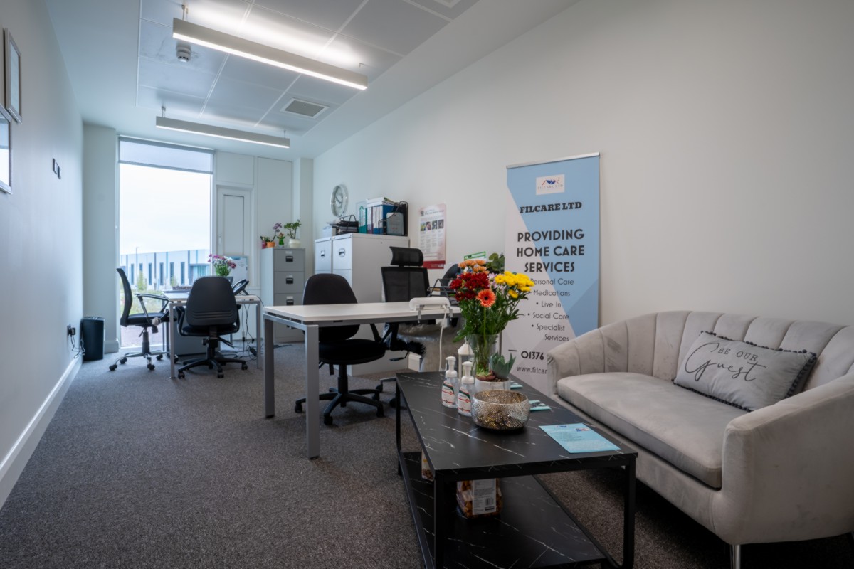 Private office with 2 tables, chairs and a sofa