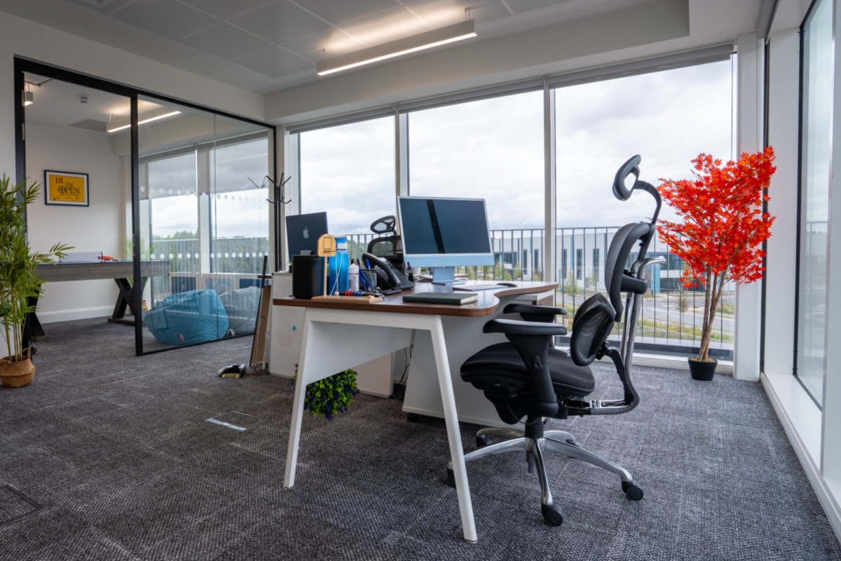 Private office with 2 tables, chairs and a balcony