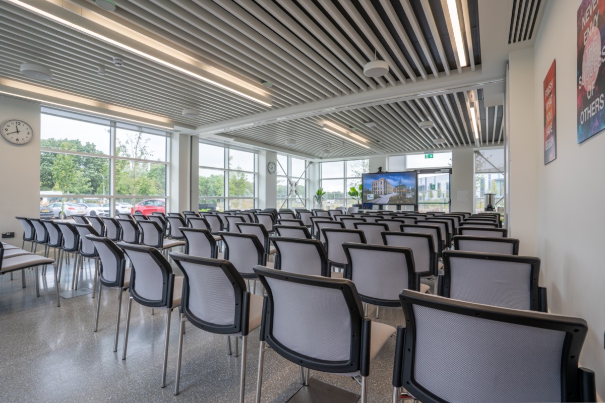 Empty conference room with a chair set up and a TV screen in the Plaza