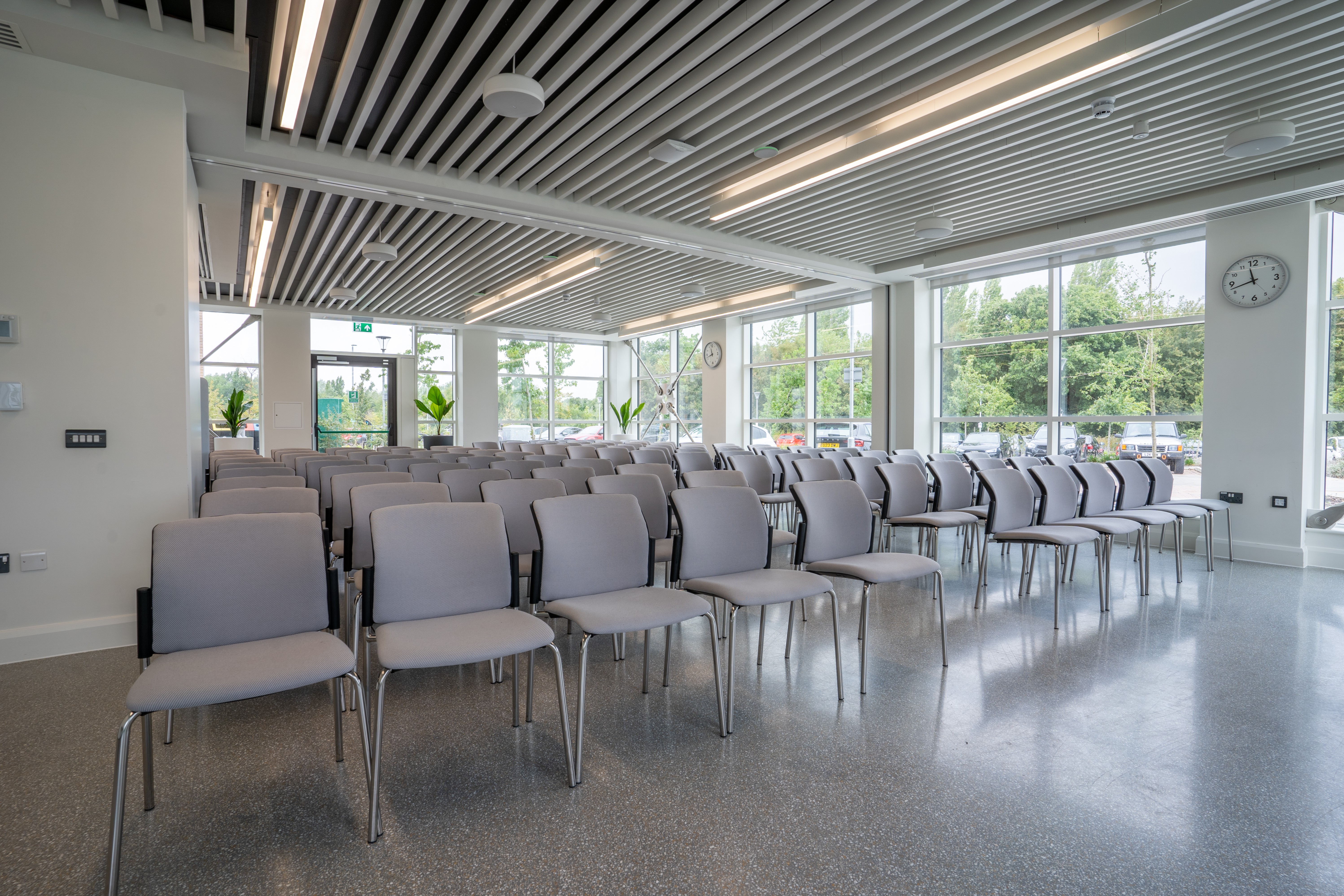 Meeting room over looking a patio balcony with chairs in the Plaza