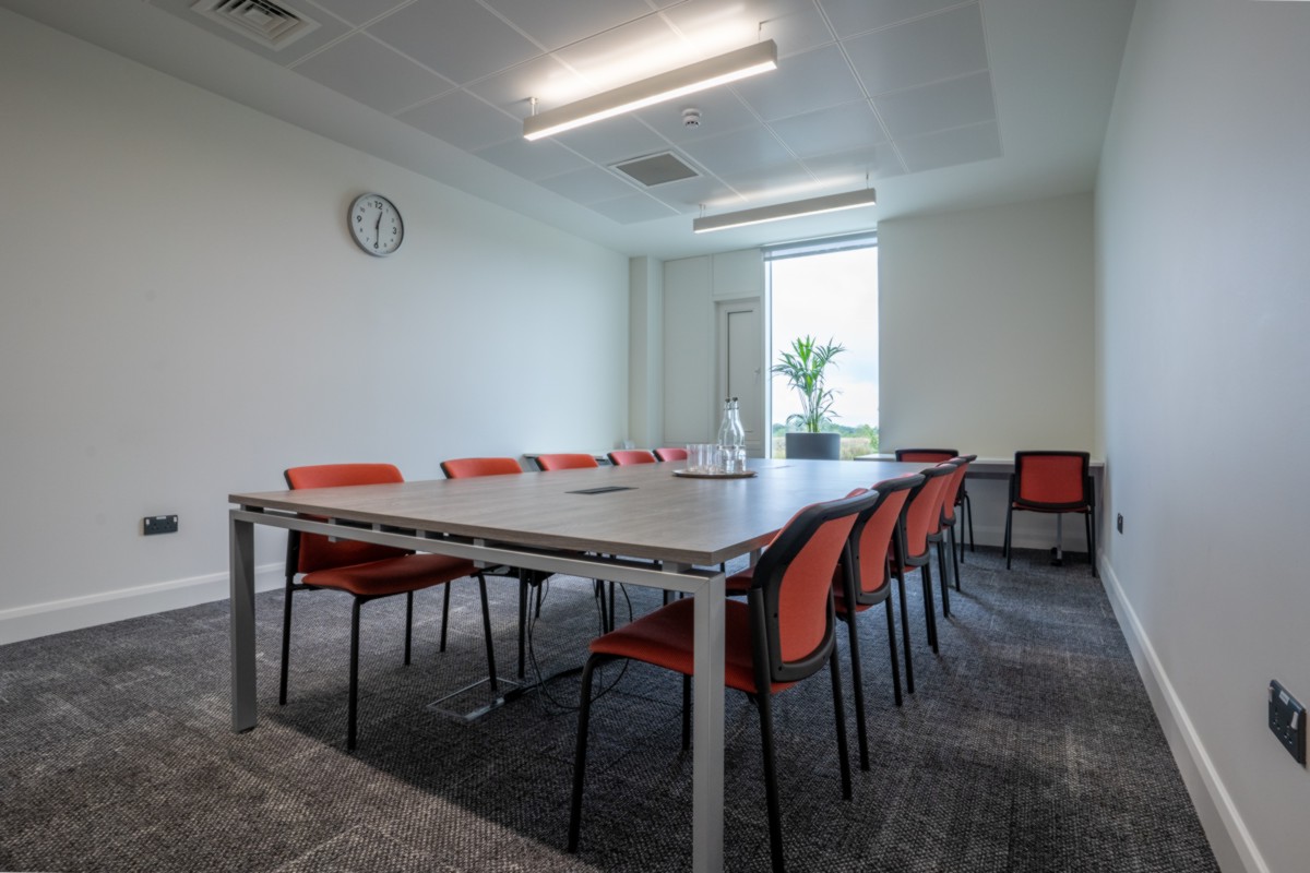 Private meeting room with a table and chairs in the Plaza